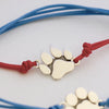 bracciale con cordino e ciondolo a forma di zampa di cane