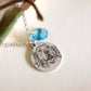 collana con cristallo. charm tondo e cristallo colore acquamarina
